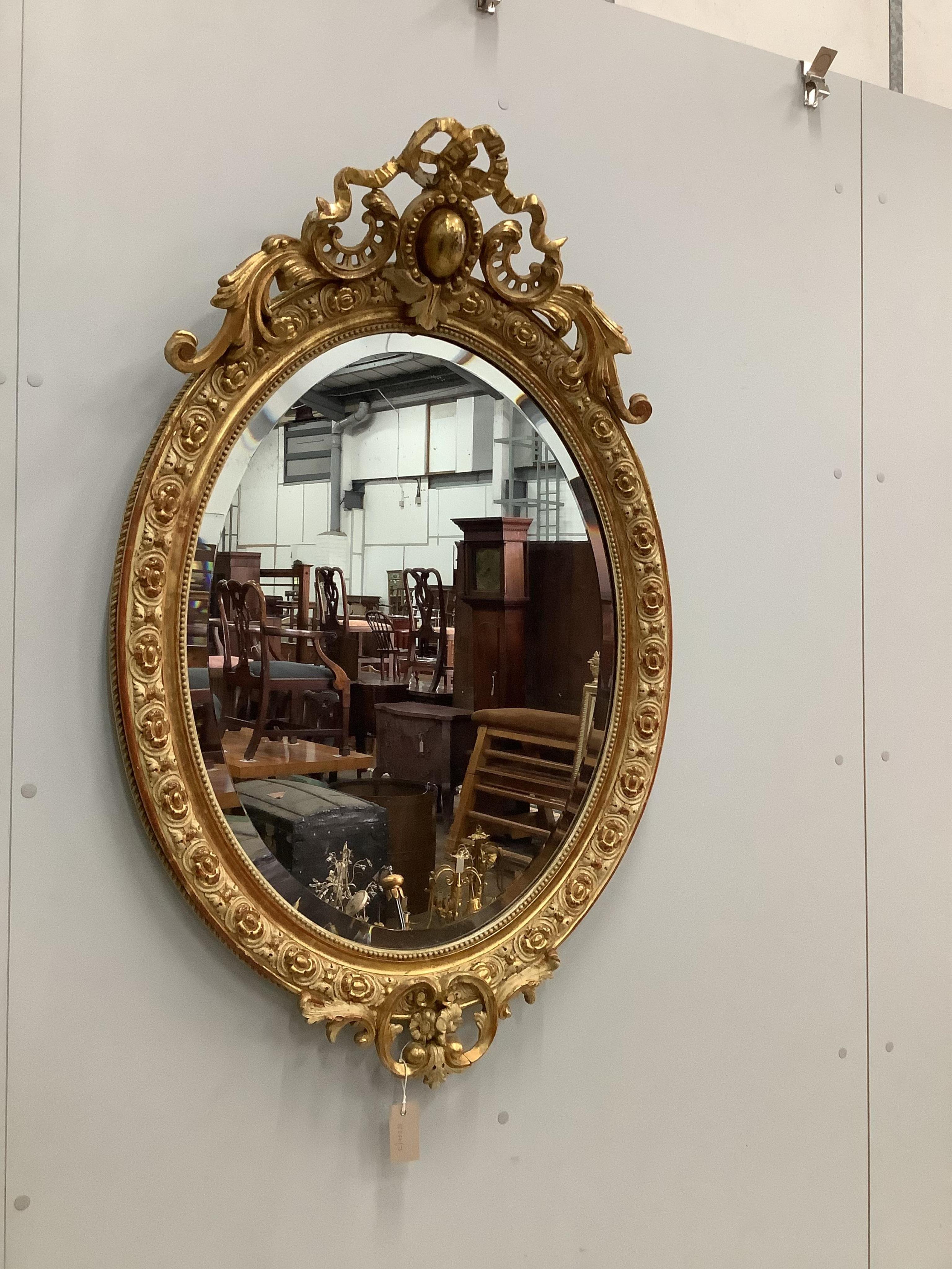 A 19th century French giltwood and gesso wall mirror, width 73cm, height 112cm. Condition - fair, some small losses to the upper crest